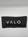 A black fabric headband with the brand name 'VALO' printed in white capital letters across the front, displayed on a neutral light gray background.