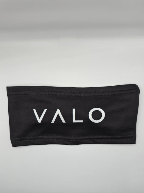 A black fabric headband with the brand name 'VALO' printed in white capital letters across the front, displayed on a neutral light gray background.
