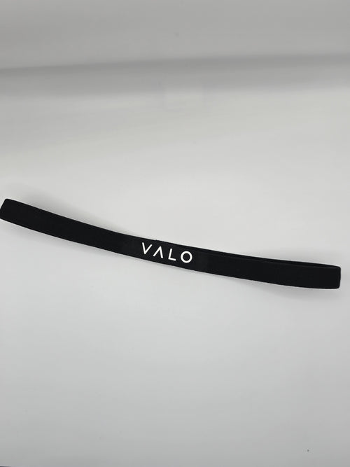 A black elastic headband with the brand name 'VALO' printed in white capital letters, displayed on a light gray background.